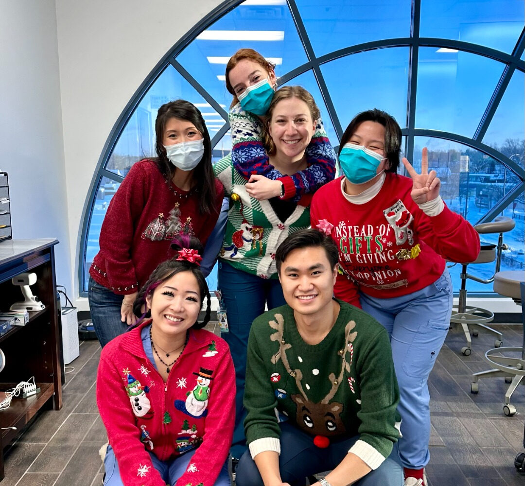 A group photo of an Ugly Holiday Sweater Contest (About Us)