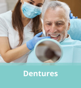 Dental Assistant & Patient looking at new Dentures